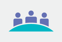 three people sat at a desk