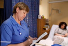 Nurse examining paperwork Nurse examining paperwork